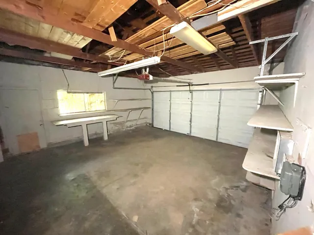 a view of a room with furniture and a window