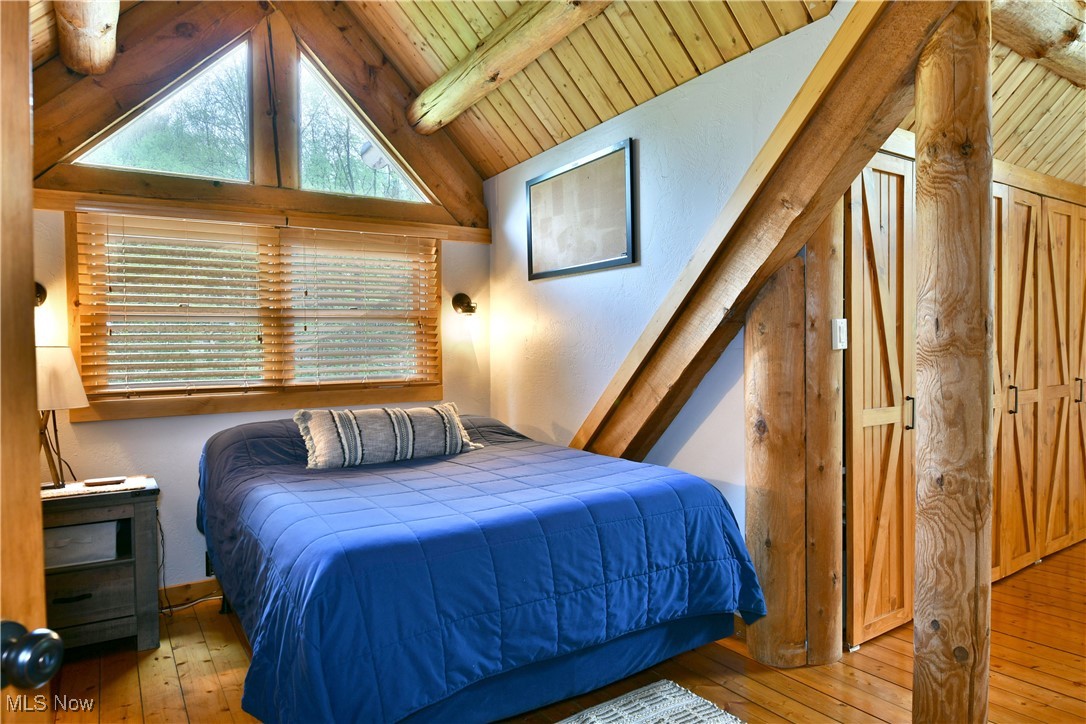 18102 Owen Road Middlefield, OH 44062 - Photo 27 of 50 Bedroom with hardwood / wood-style flooring and wood ceiling