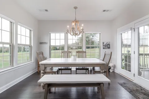 a view of a dining room with furniture window and wooden floor