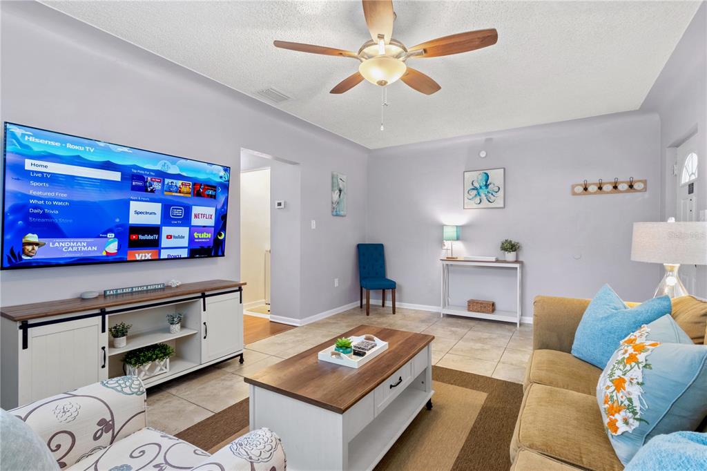 5596 100th Way North St. Petersburg, FL 33708 - Photo 5 of 67 a living room with furniture and a flat screen tv