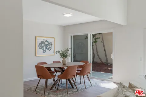 a view of a dining room with a table and chairs
