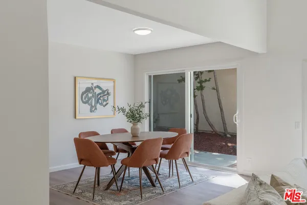 a view of a dining room with a table and chairs