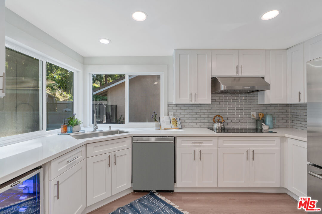 19 Rippling Streme Irvine, CA 92603 - Photo 22 of 69 a kitchen with a sink stove and cabinets