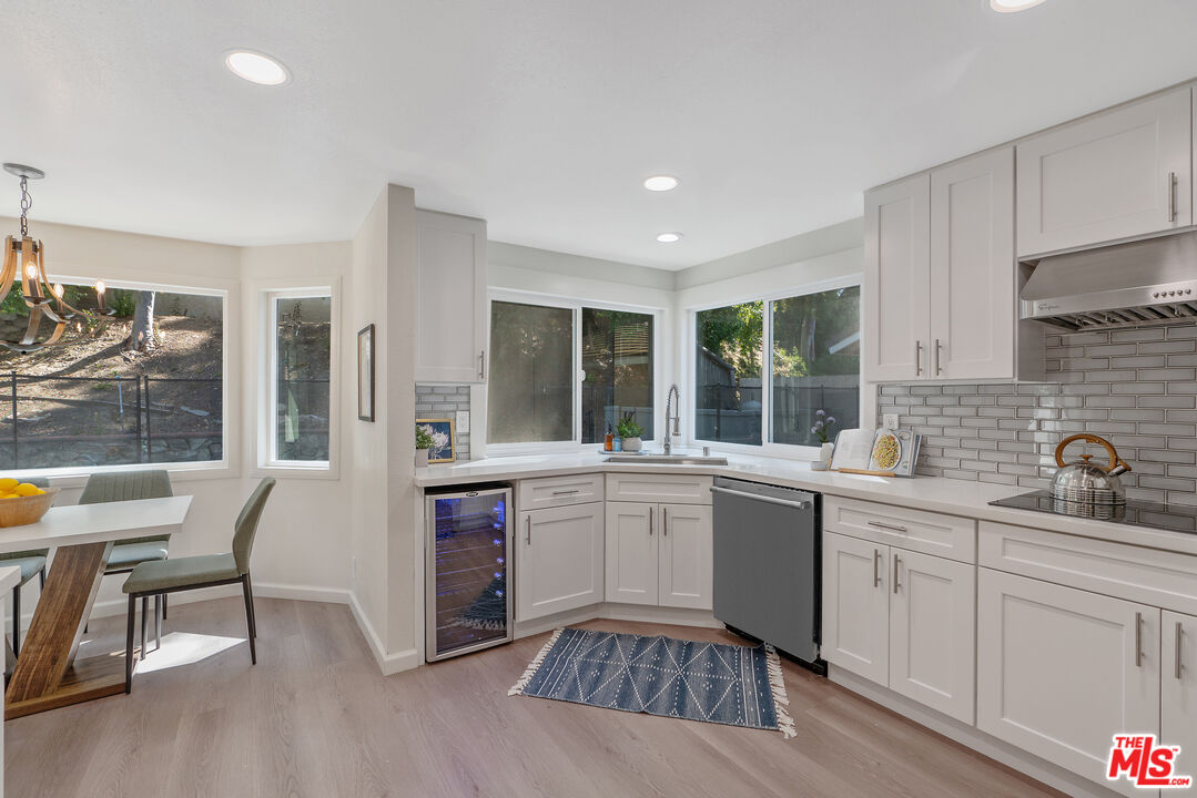 19 Rippling Streme Irvine, CA 92603 - Photo 23 of 69 a kitchen with a sink and chairs