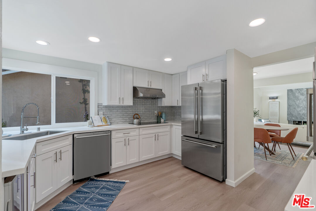 19 Rippling Streme Irvine, CA 92603 - Photo 24 of 69 a kitchen with stainless steel appliances granite countertop a refrigerator and a sink
