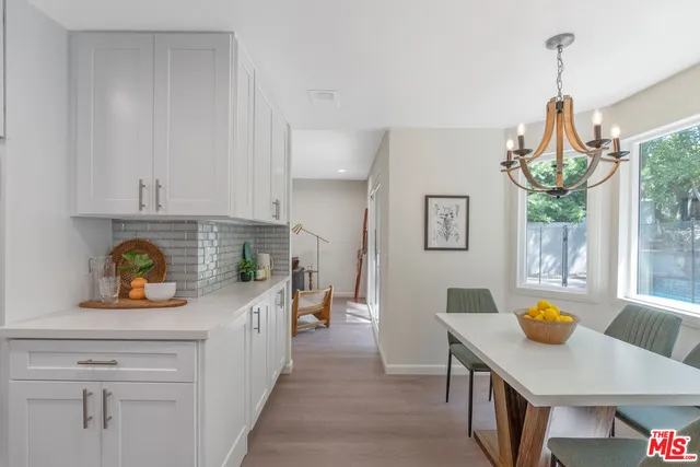 a spacious bedroom with a bed a couch and dresser