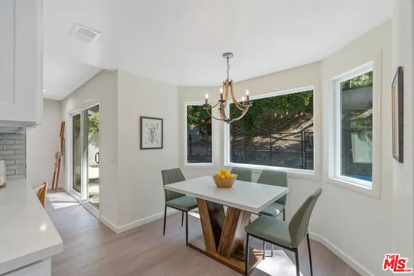 a spacious bedroom with a bed and a potted plant