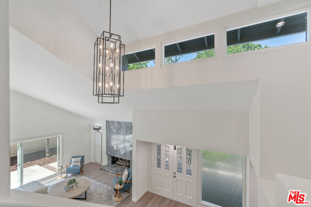 19 Rippling Streme Irvine, CA 92603 - Photo 27 of 69 a living room with furniture and a chandelier