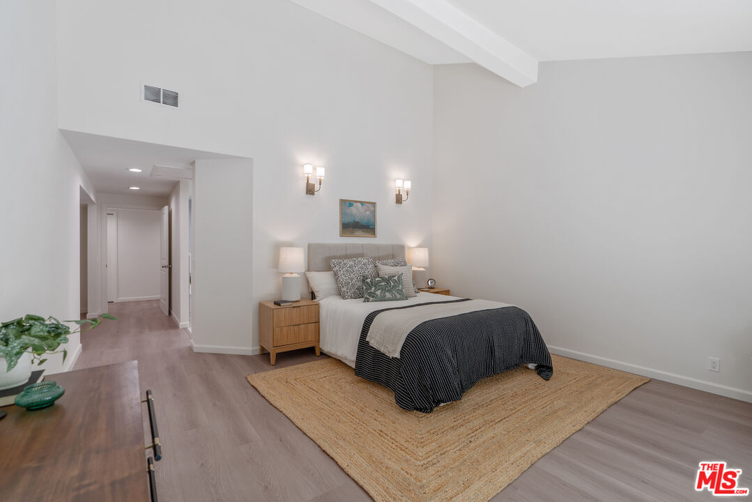 19 Rippling Streme Irvine, CA 92603 - Photo 31 of 69 a spacious bedroom with a bed and a potted plant