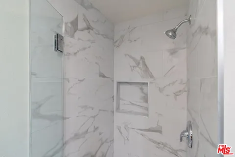 a bathroom with a sink and mirror with toilet