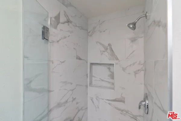 a bathroom with a sink and mirror with toilet
