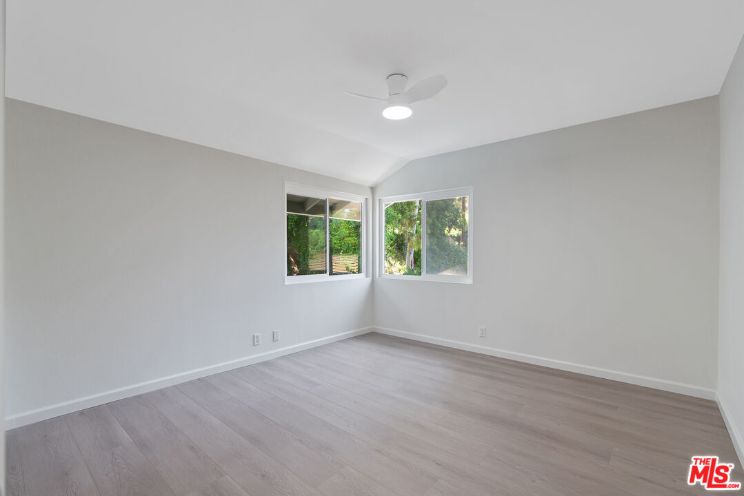 19 Rippling Streme Irvine, CA 92603 - Photo 38 of 69 an empty room with wooden floor and windows
