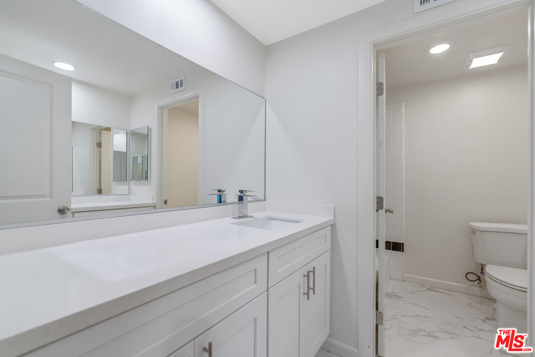 19 Rippling Streme Irvine, CA 92603 - Photo 46 of 69 a bathroom with a sink and mirror with toilet