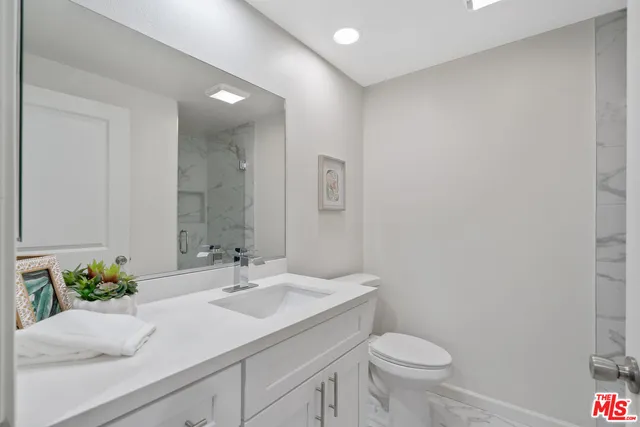 a view of a street with potted plants