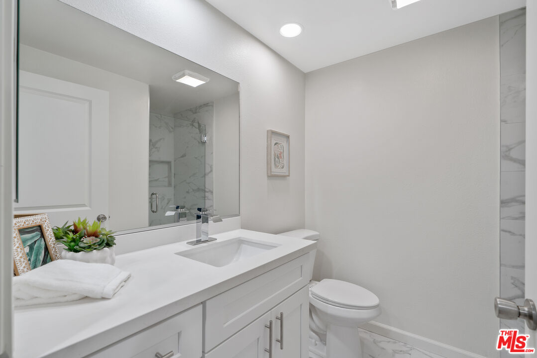 19 Rippling Streme Irvine, CA 92603 - Photo 47 of 69 a bathroom with a sink toilet and a mirror