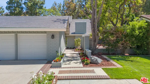 an aerial view of a house with garden space and street view