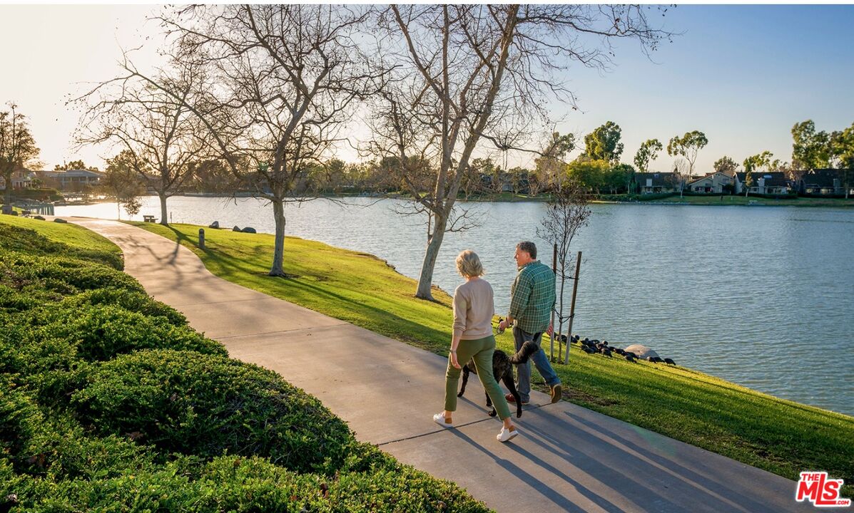 19 Rippling Streme Irvine, CA 92603 - Photo 67 of 69 a view of a lake with a bench and trees in the background