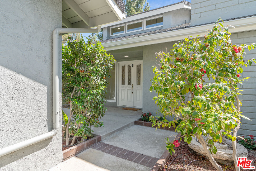 19 Rippling Streme Irvine, CA 92603 - Photo 8 of 69 a potted plant is sitting in front of a house