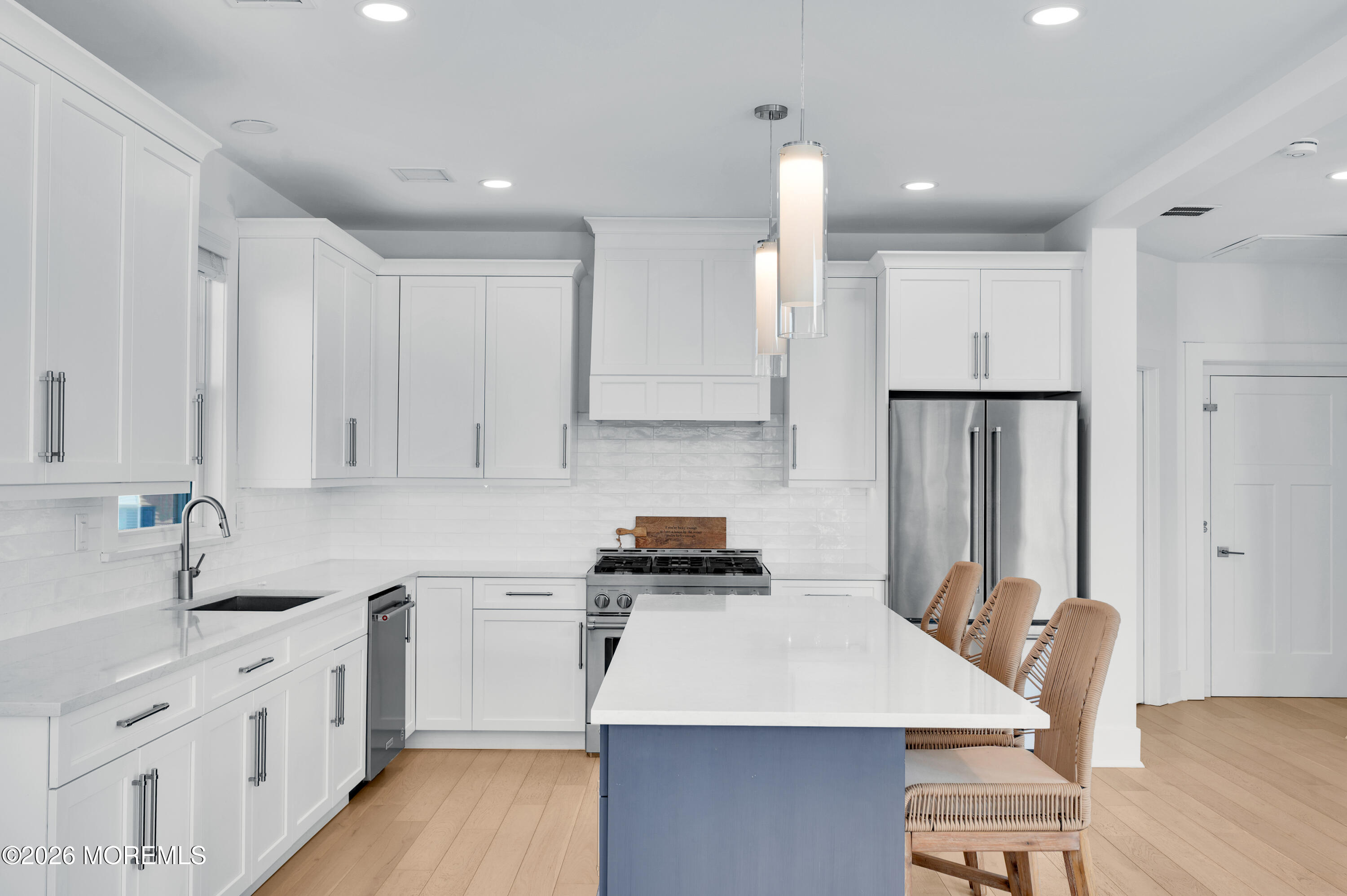 2000 Highway 35 Seaside Heights, NJ 08751 - Photo 7 of 55 a kitchen with stainless steel appliances a stove a sink a refrigerator white cabinets and wooden floor