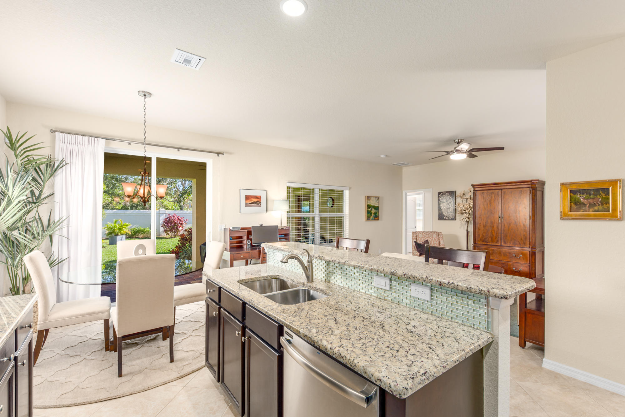 151 Rudder Cay Way Jupiter, FL 33458 - Photo 11 of 32 a view of a kitchen with granite countertop a sink and a refrigerator