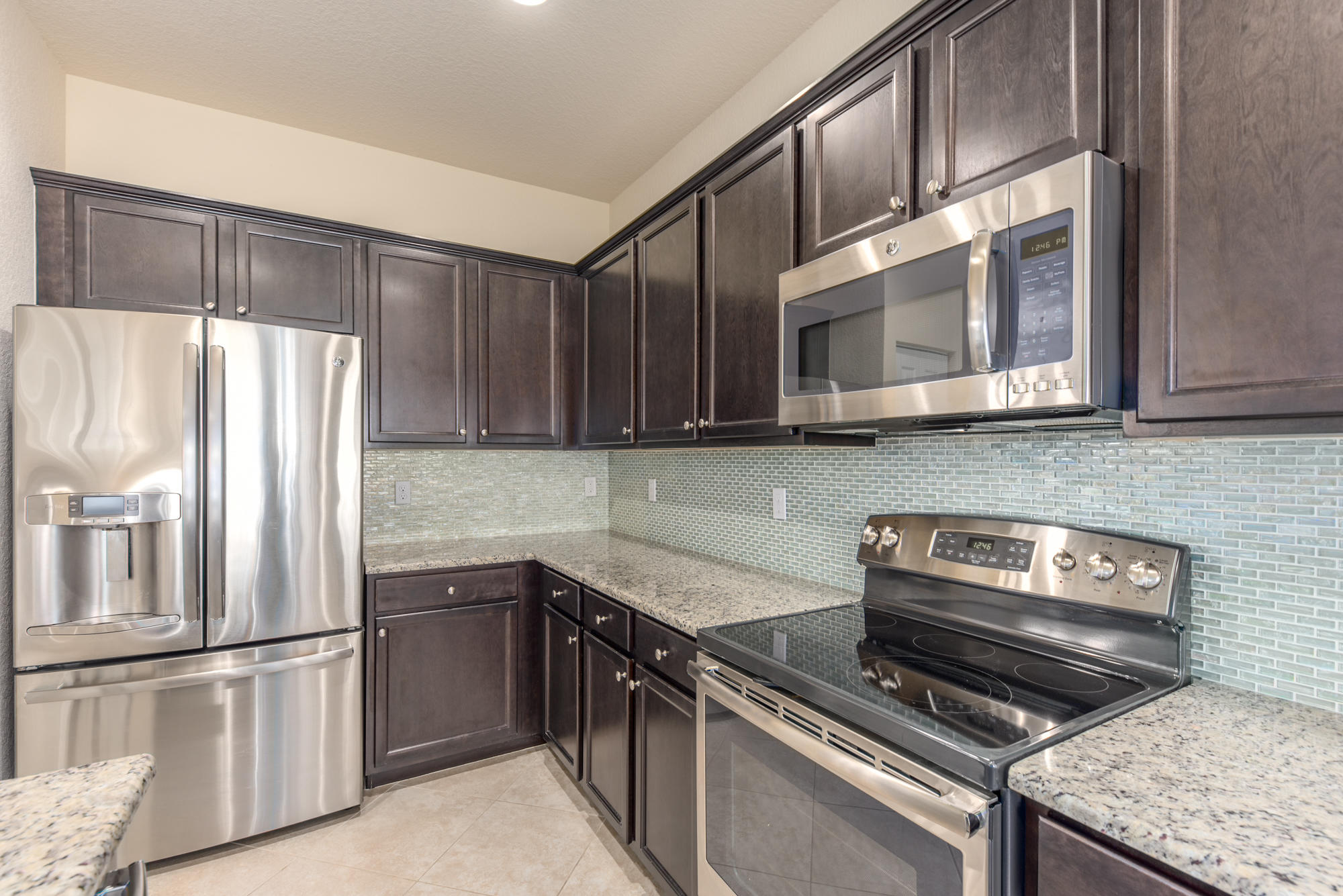 151 Rudder Cay Way Jupiter, FL 33458 - Photo 12 of 32 a kitchen with a refrigerator stove and microwave