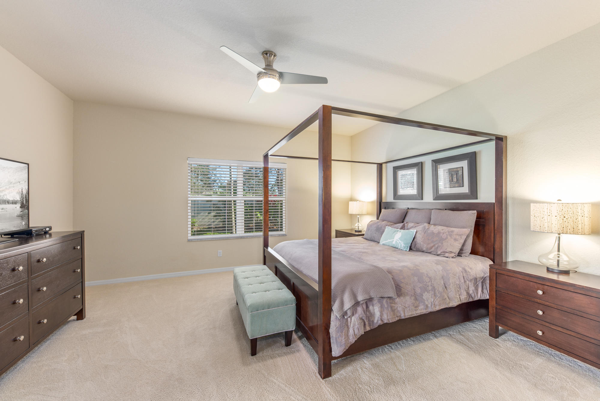 151 Rudder Cay Way Jupiter, FL 33458 - Photo 13 of 32 a bedroom with a large bed and a tv on dresser
