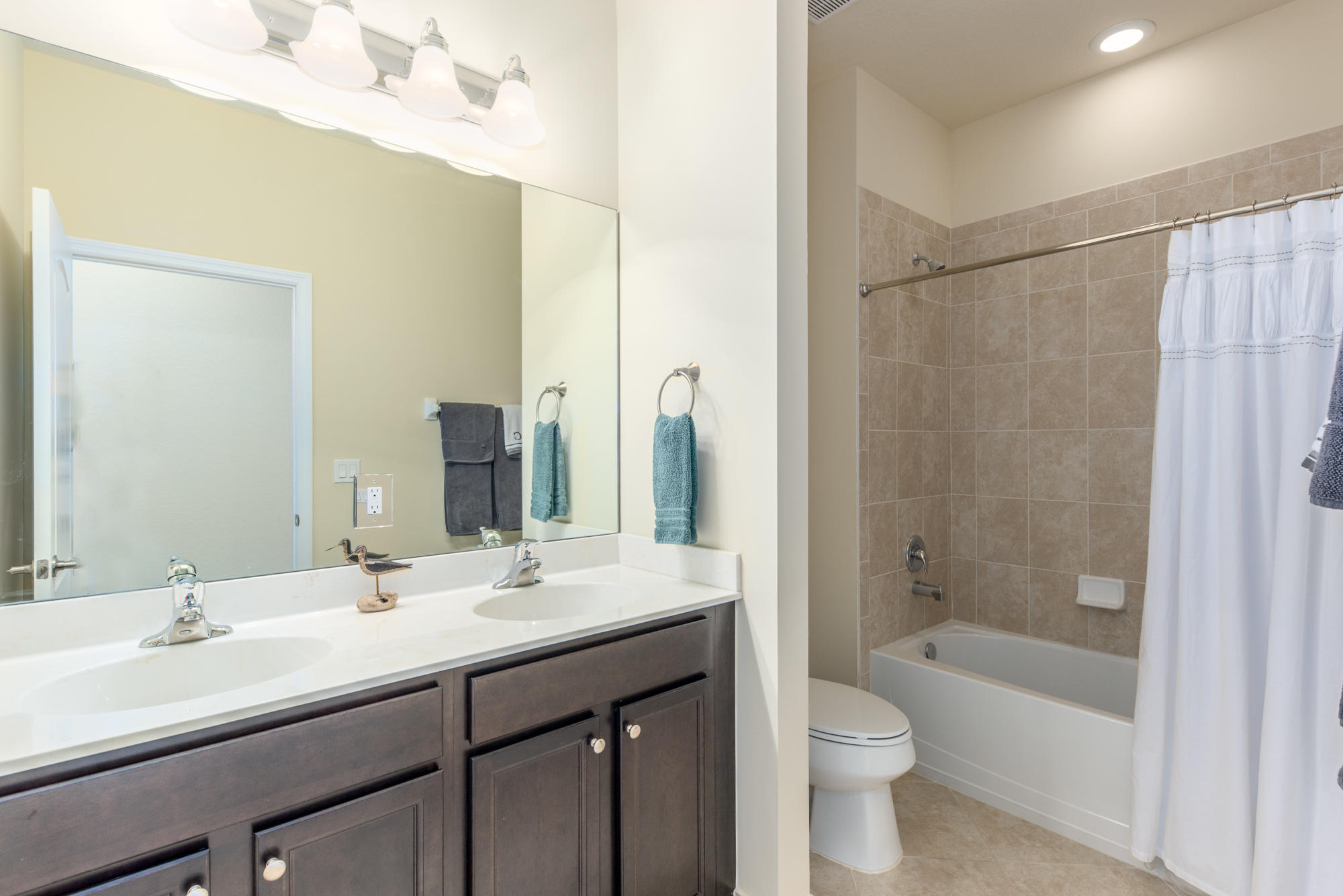 151 Rudder Cay Way Jupiter, FL 33458 - Photo 19 of 32 a bathroom with a bathtub shower sink vanity mirror and toilet