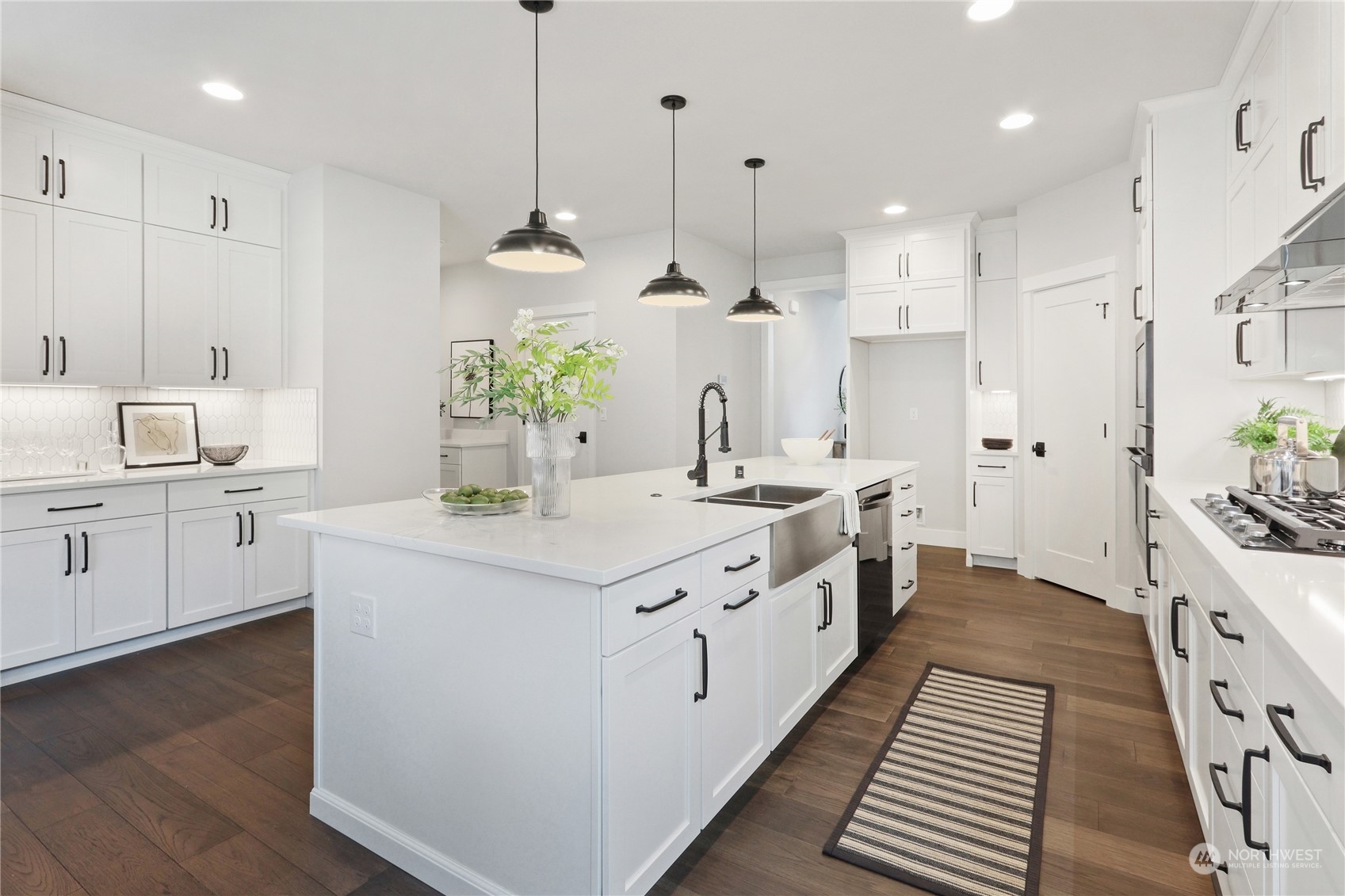 3915 211th Place Southeast Bothell, WA 98021 - Photo 11 of 24 a large kitchen with white cabinets and stainless steel appliances