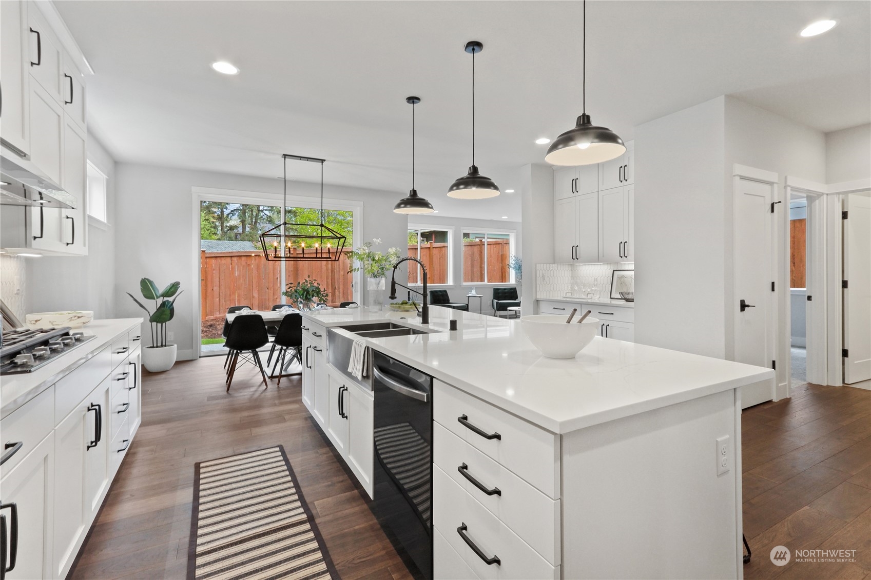 3915 211th Place Southeast Bothell, WA 98021 - Photo 13 of 24 a kitchen with stainless steel appliances a stove a sink a center island a dining table and chairs