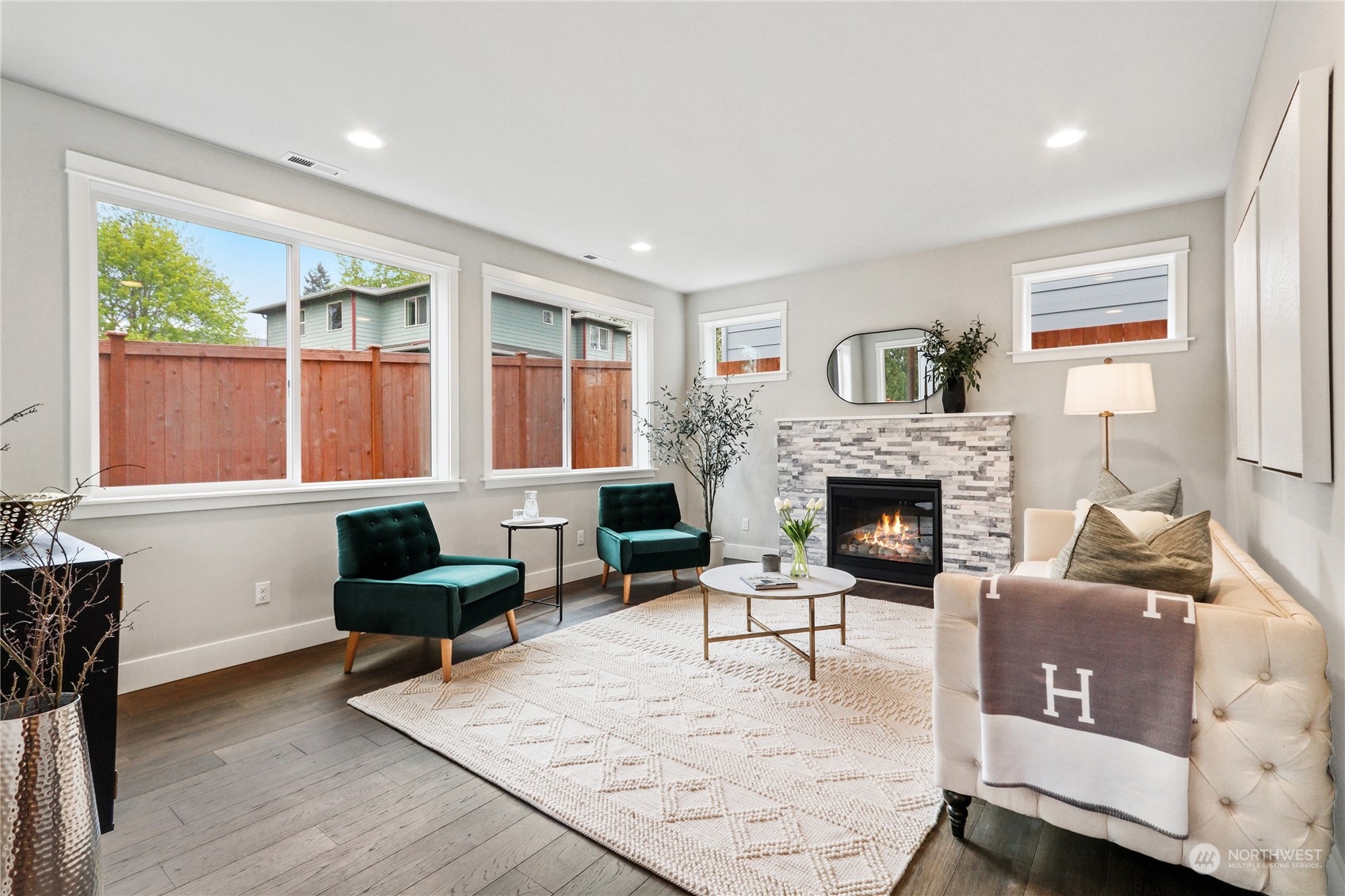 3915 211th Place Southeast Bothell, WA 98021 - Photo 6 of 24 a living room with furniture a large window and a fireplace