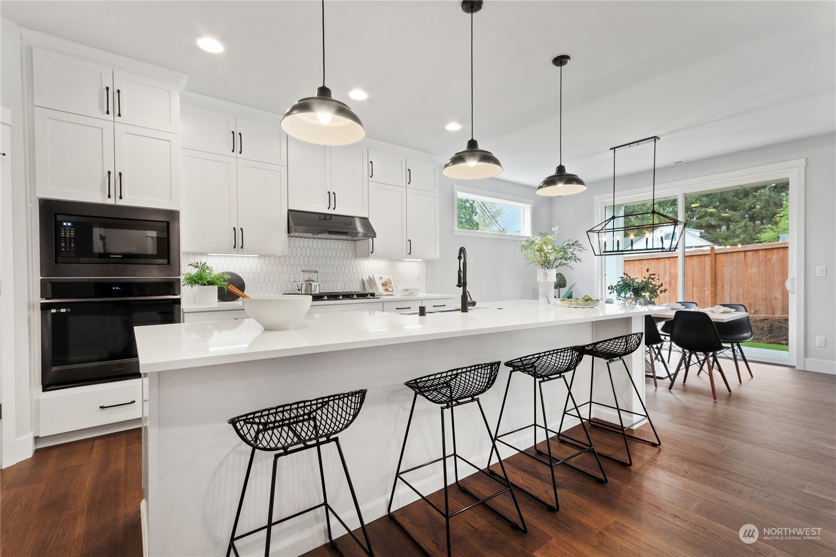 3915 211th Place Southeast Bothell, WA 98021 - Photo 9 of 24 a kitchen with stainless steel appliances granite countertop a stove a kitchen island a stove a kitchen island a dining table and chairs