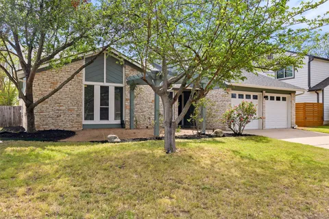 a front view of house with yard and trees