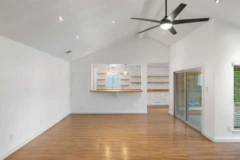 a kitchen with a sink and a wooden floor