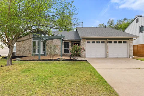 a front view of house with yard and green space