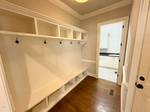 a view of walk in closet with wooden floor
