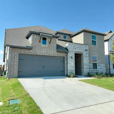 a front view of a house with garage