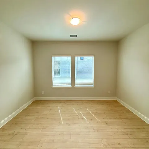 an empty room with a empty space and windows