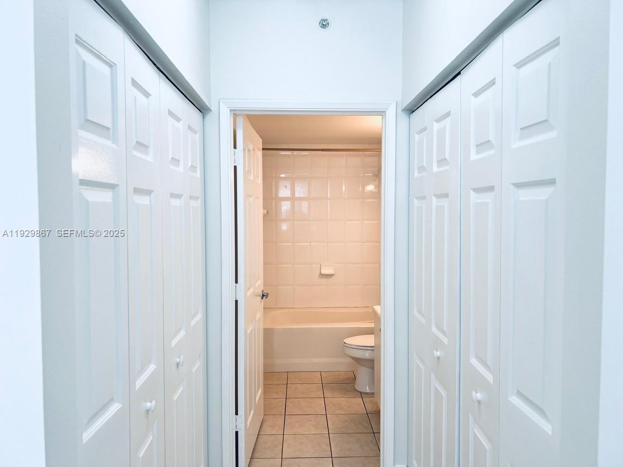 8000 North Nob Hill Road, Unit 204 Tamarac, FL 33321 - Photo 12 of 27 a bathroom with a glass shower door