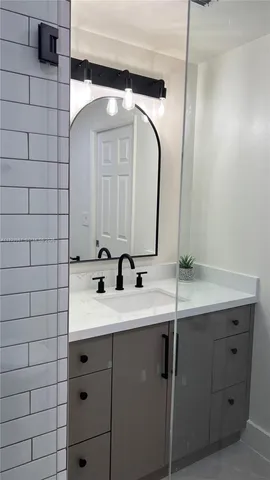 a bathroom with a sink and a mirror