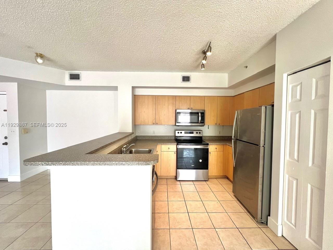 8000 North Nob Hill Road, Unit 204 Tamarac, FL 33321 - Photo 3 of 27 a kitchen with a refrigerator sink and stove