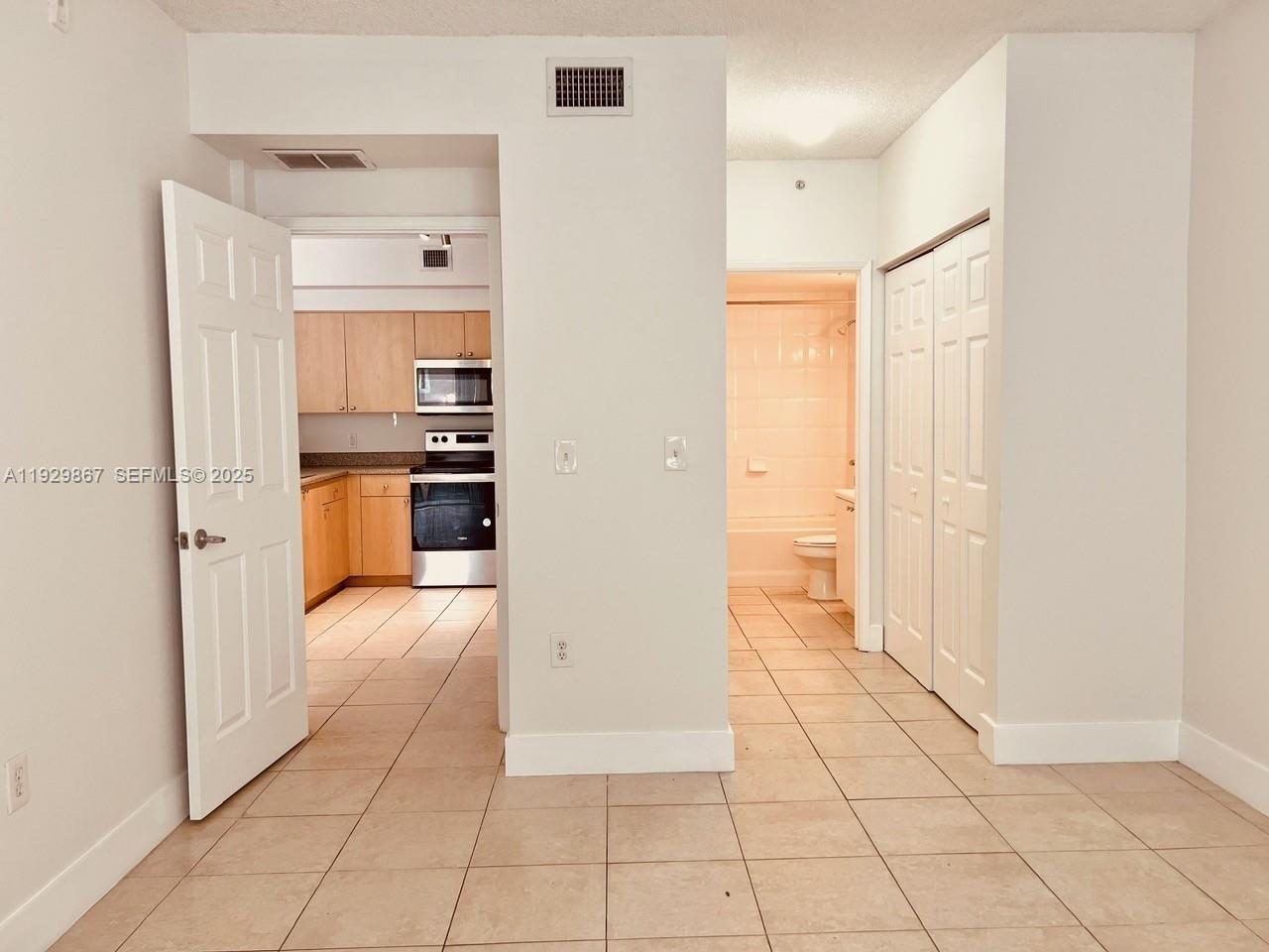 8000 North Nob Hill Road, Unit 204 Tamarac, FL 33321 - Photo 4 of 27 a view of a kitchen with kitchen and refrigerator