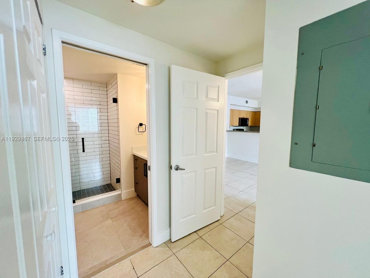 8000 North Nob Hill Road, Unit 204 Tamarac, FL 33321 - Photo 9 of 27 a view of a hallway with white cabinets and entryway