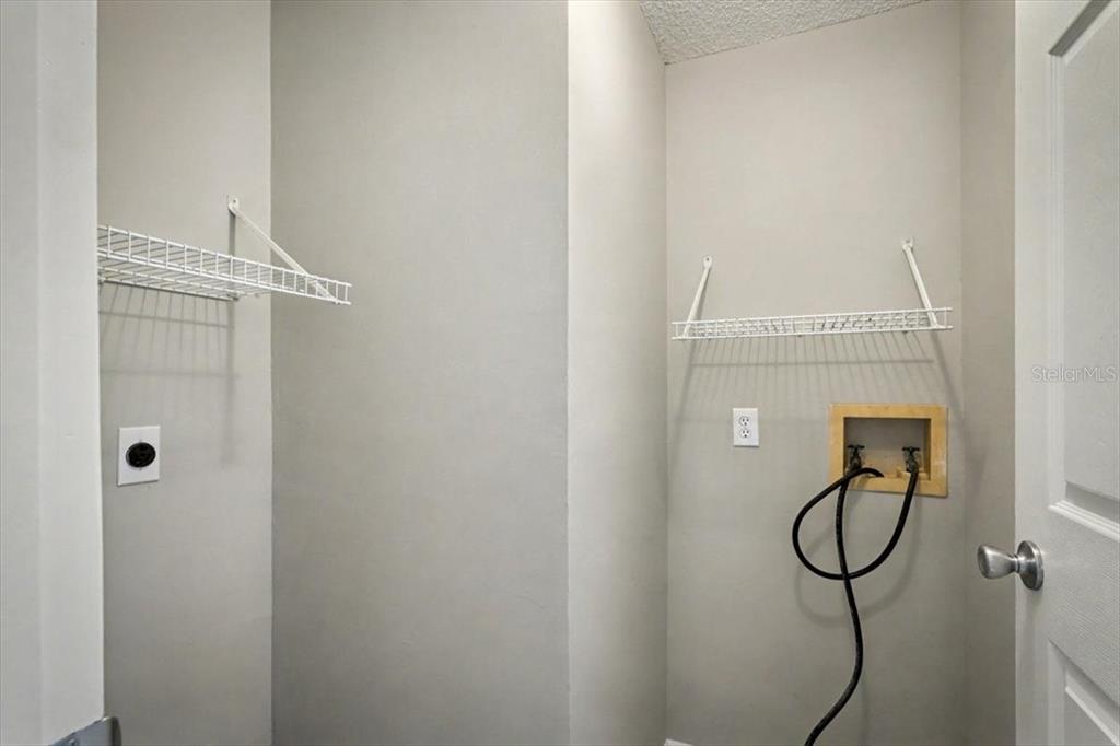 173 North Ridgewood Avenue Ormond Beach, FL 32174 - Photo 18 of 33 a bathroom with a glass shower door