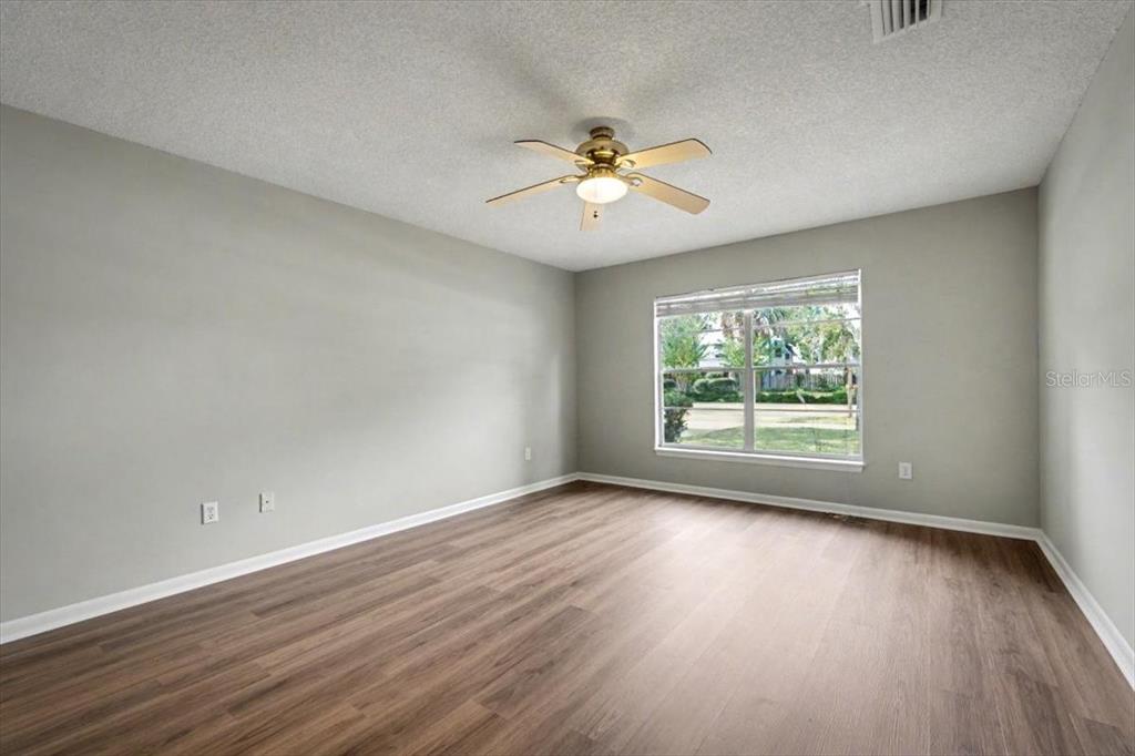173 North Ridgewood Avenue Ormond Beach, FL 32174 - Photo 26 of 33 wooden floor in an empty room with a window