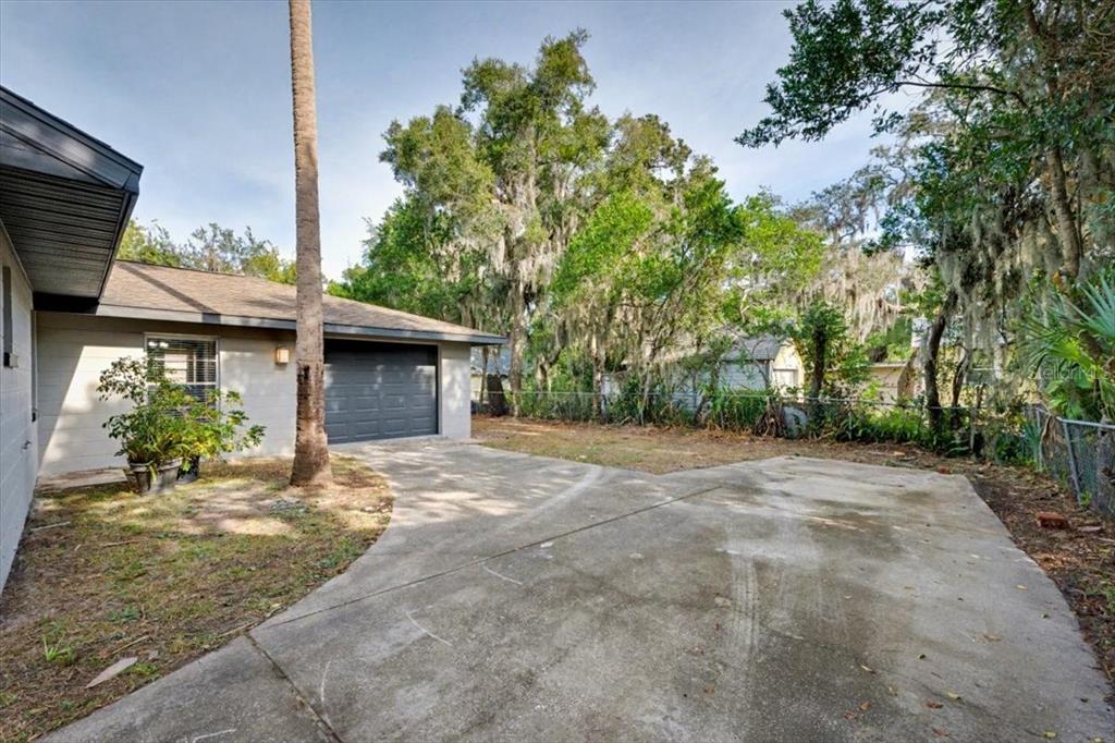 173 North Ridgewood Avenue Ormond Beach, FL 32174 - Photo 33 of 33 a view of a house with a yard and potted plants