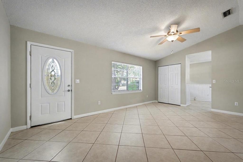 173 North Ridgewood Avenue Ormond Beach, FL 32174 - Photo 7 of 33 a view of an empty room with window chandelier fan
