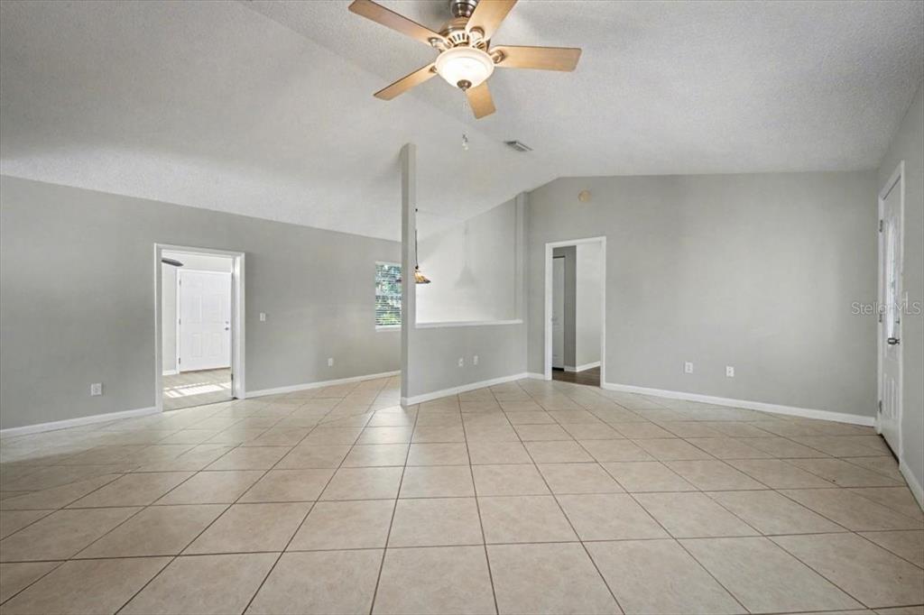 173 North Ridgewood Avenue Ormond Beach, FL 32174 - Photo 9 of 33 a view of an empty room with a chandelier fan