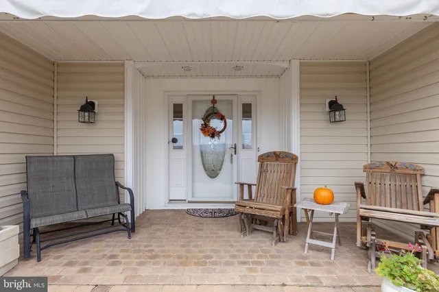 a front view of a house with mountain view and a potted plant