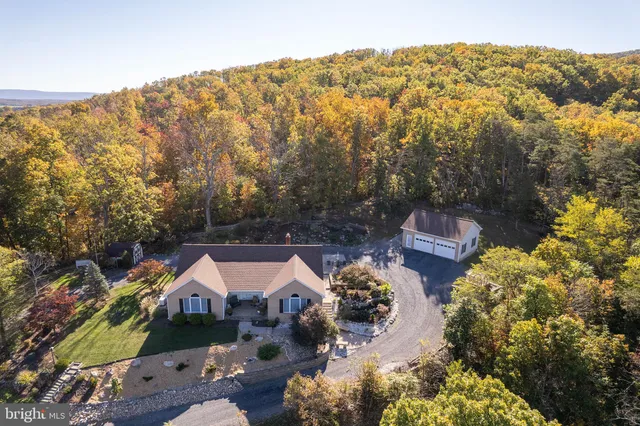 an aerial view of a house with a yard basket ball court and outdoor seating