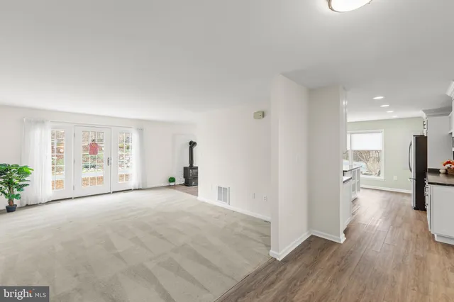 a view of a kitchen with furniture and wooden floor